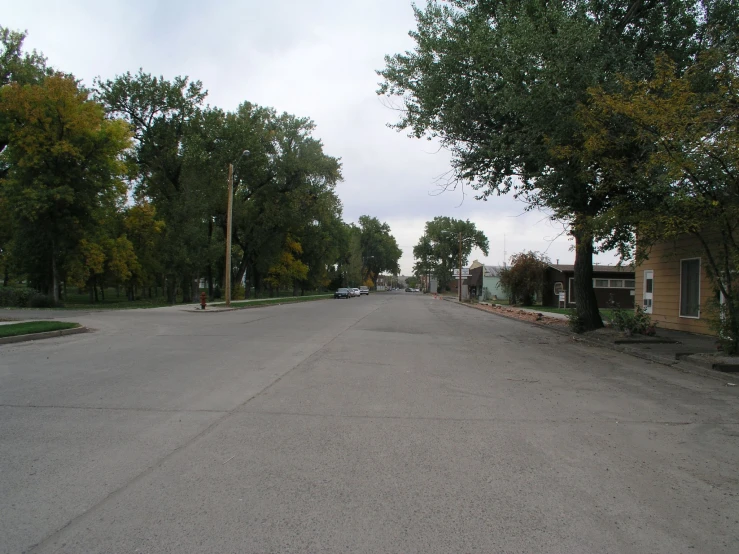 a stop sign is on the side of an empty road