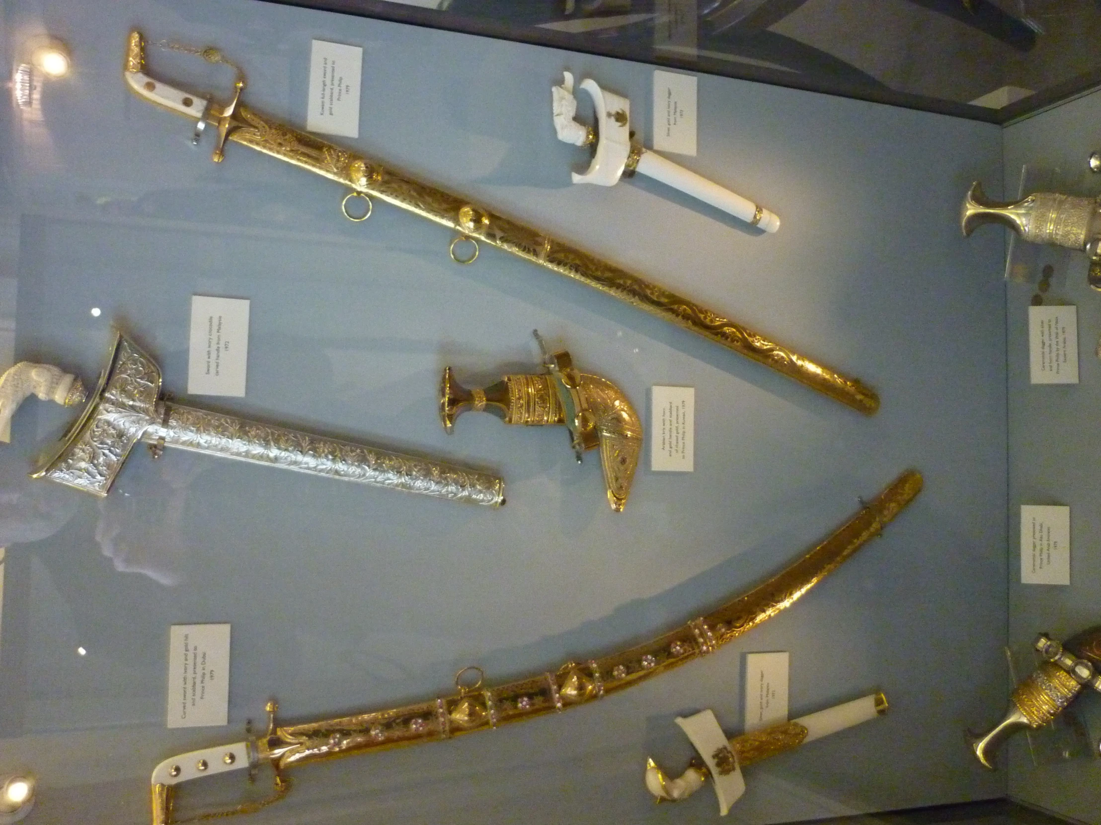 four different types of knives sitting in a display case