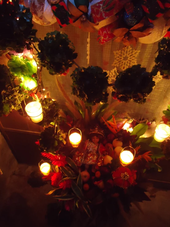 candles sit on a table beside holiday decorations