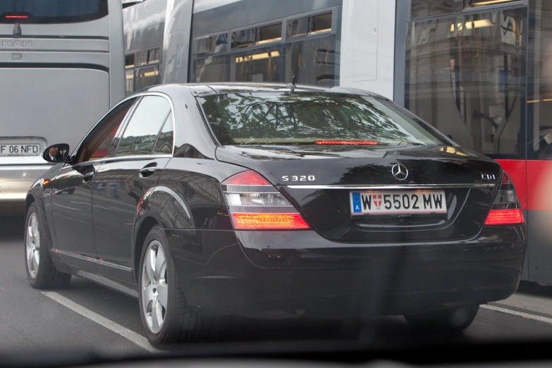 black mercedes benz cls on city road in traffic