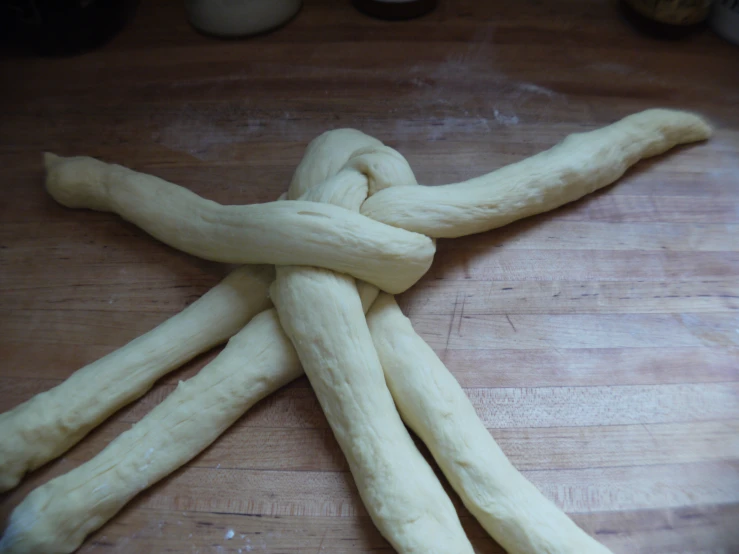 uncooked long - shaped pretzels sitting on the  board