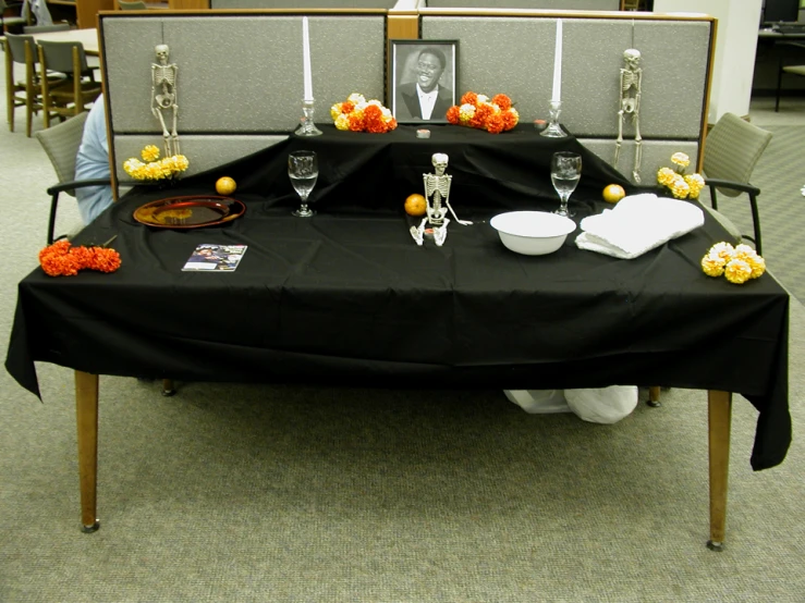 a dining table with decorations and chairs in an office