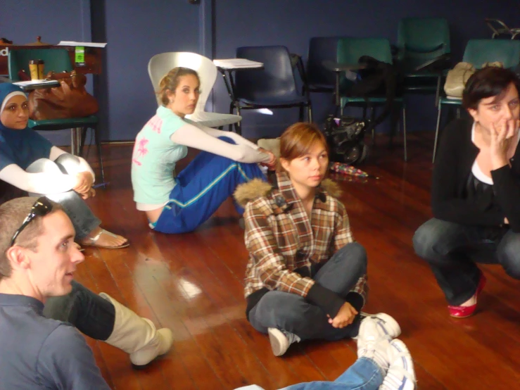 a group of people sit on the floor as people play games