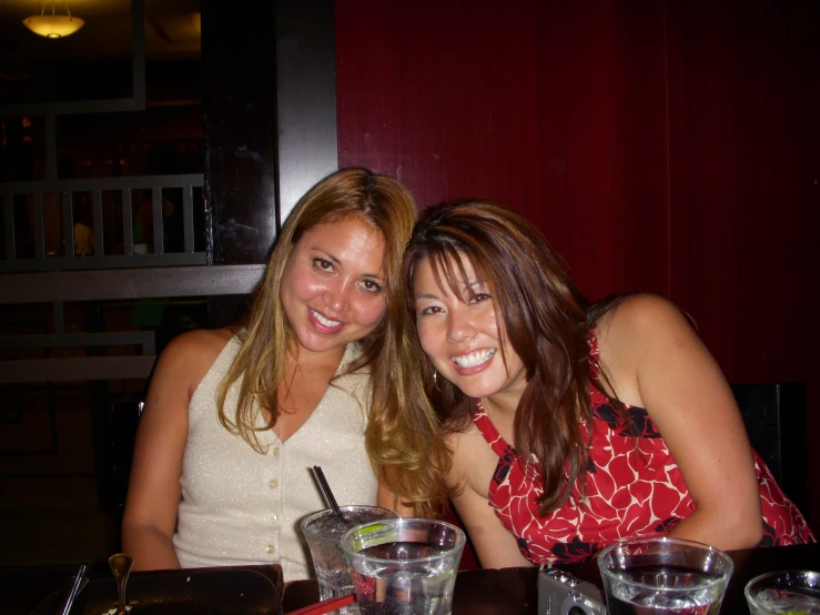 two woman sitting in front of each other at a restaurant