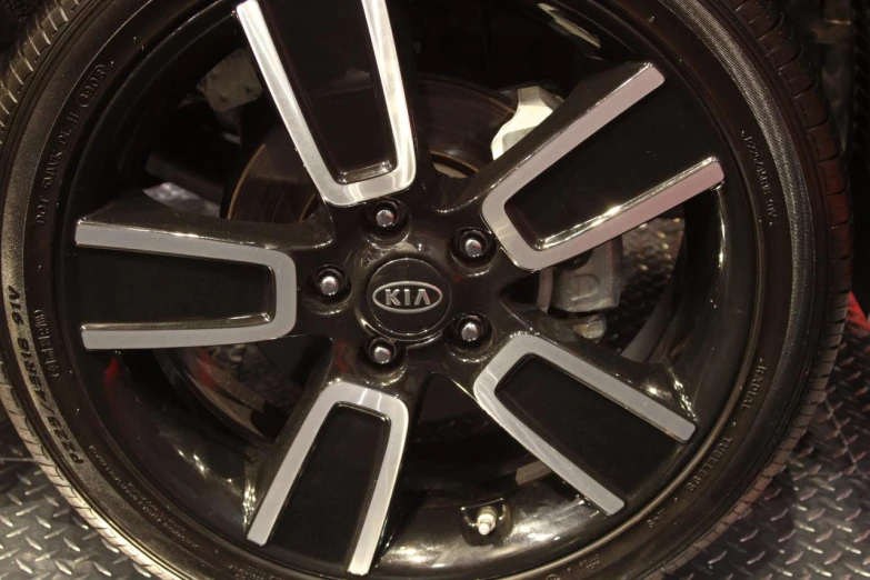 a car tire with all new polished black spokes