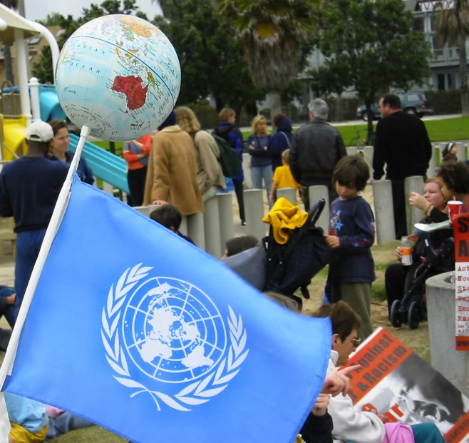 a flag and ball on a post at an event