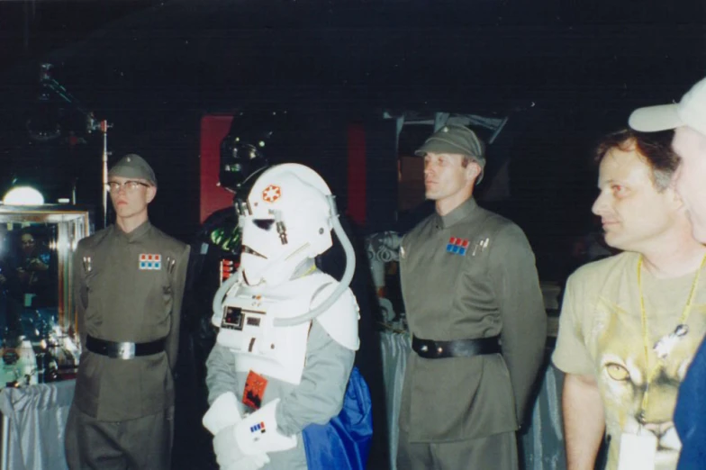 two men in uniforms talking with a star wars commander