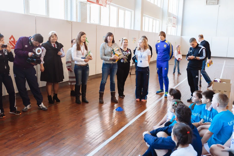 several students in a room watching a teacher teach