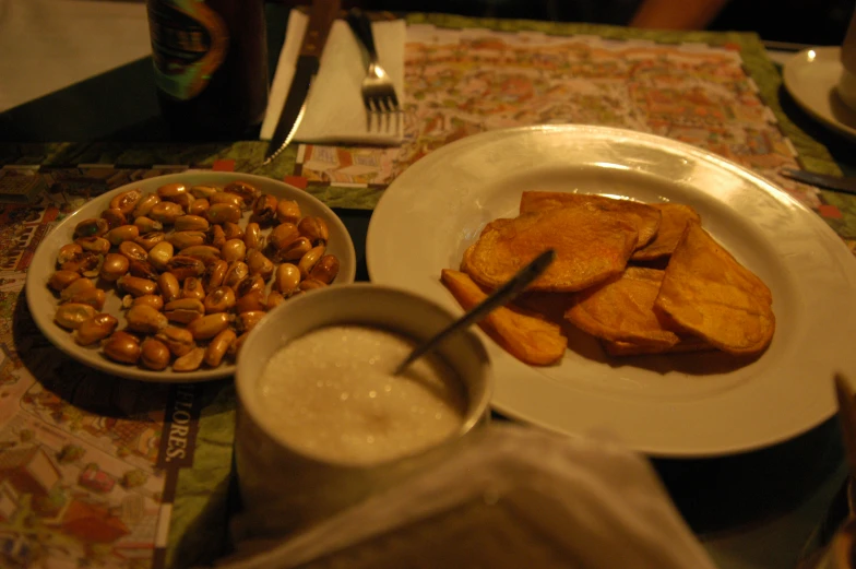 a meal set out on a table with a small bowl of peanuts