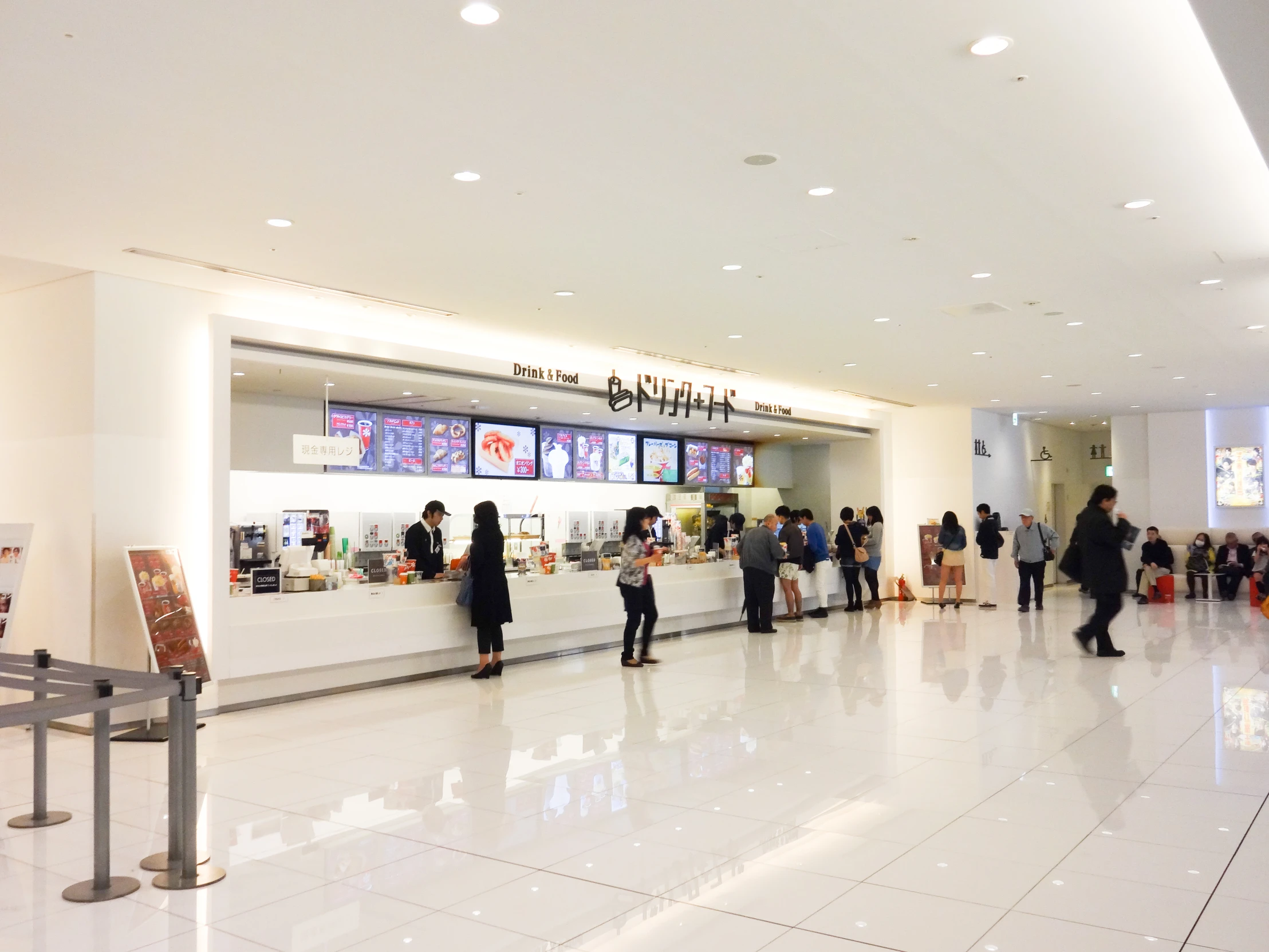 people are standing in the lobby of an airport