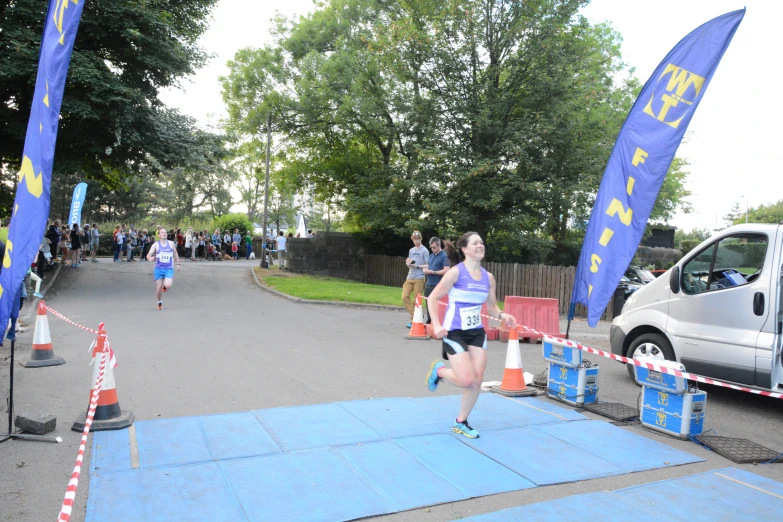 a man is running across a race course