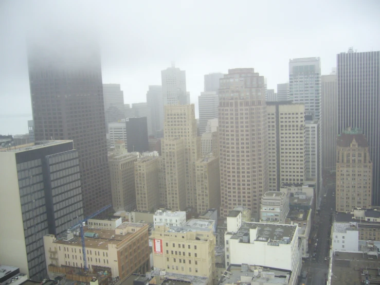 a picture of the skyline in the fog from high rise buildings