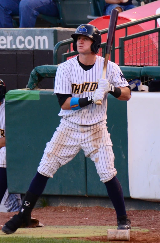 a baseball player that is standing up with a bat