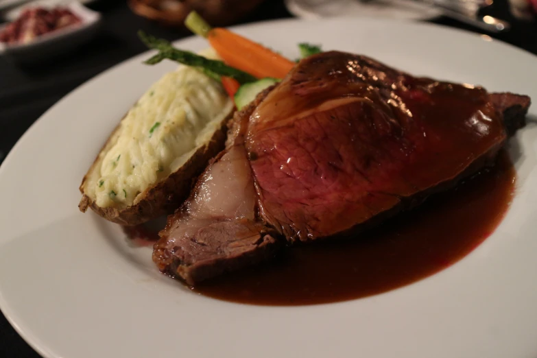 a meat with red sauce sitting on top of a plate