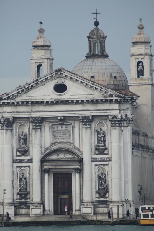 an old cathedral sitting in a body of water