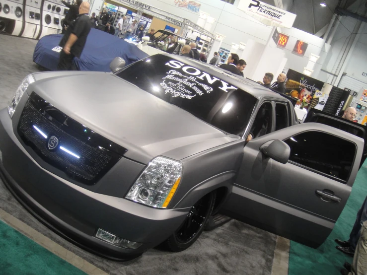 a gray pick up truck is displayed at an auto show