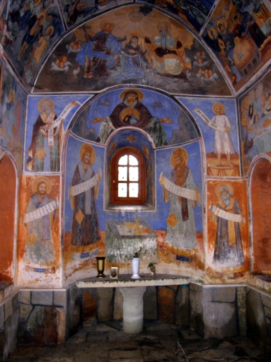 a colorful wall with religious paintings around it