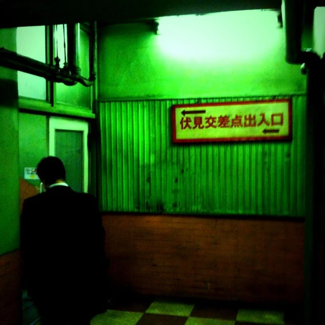 a man in a suit standing in an underground subway