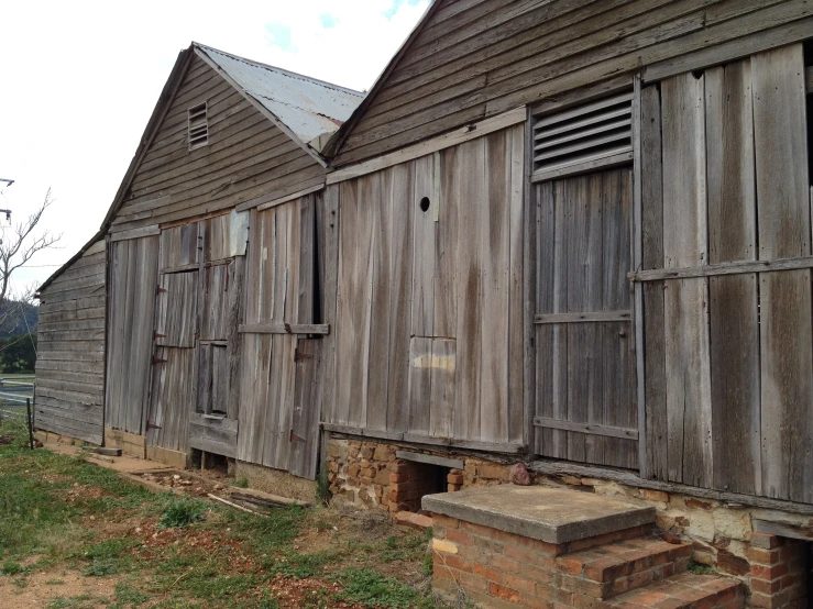 an old building with three windows and steps