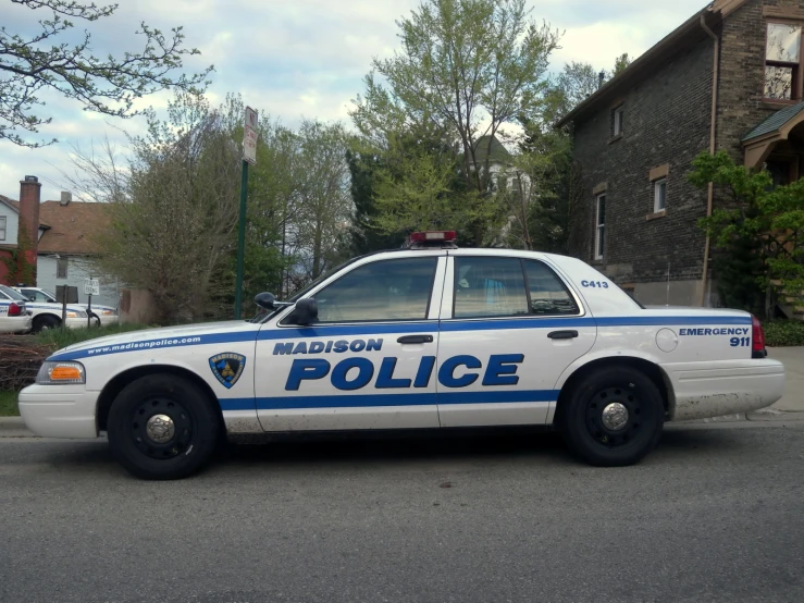 a police car on a street near houses