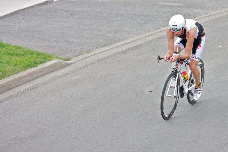 a man riding a bike down the street