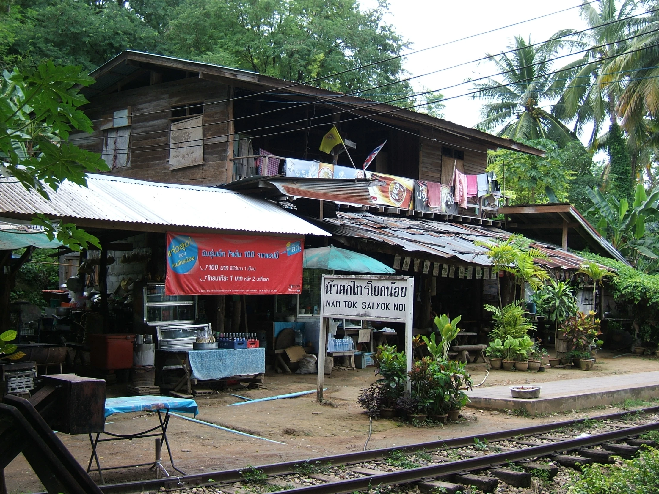 a building next to a railroad track with a large sign on it