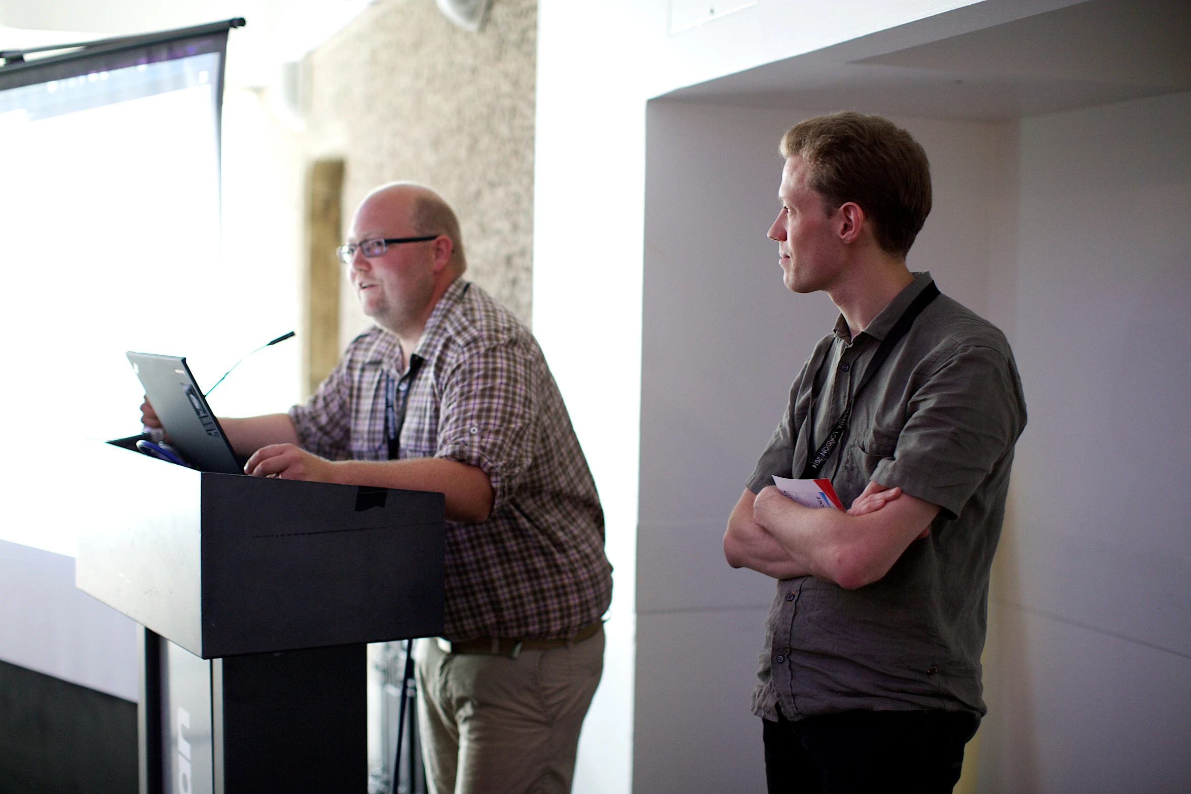 two people that are standing at a podium