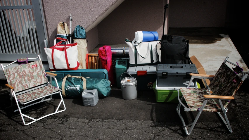 a bunch of luggage and other items are stacked outside