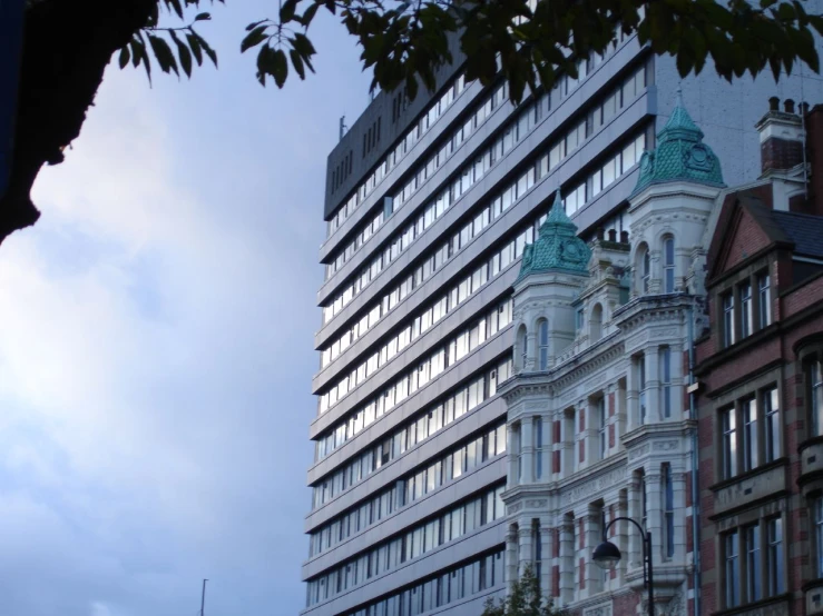 the very tall building is surrounded by other buildings