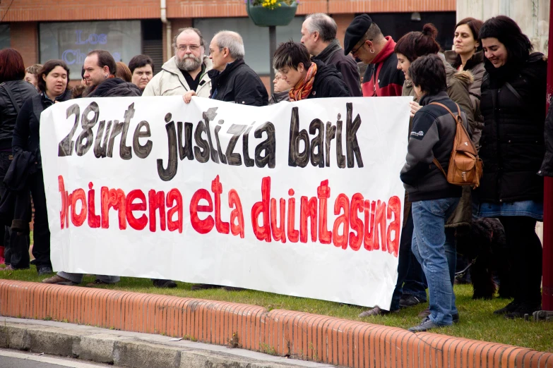 protestors protesting on the side of the street holding a sign that reads reduce your junk parking