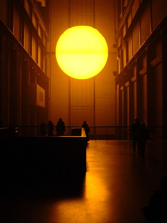 several people are standing in a dimly lit area