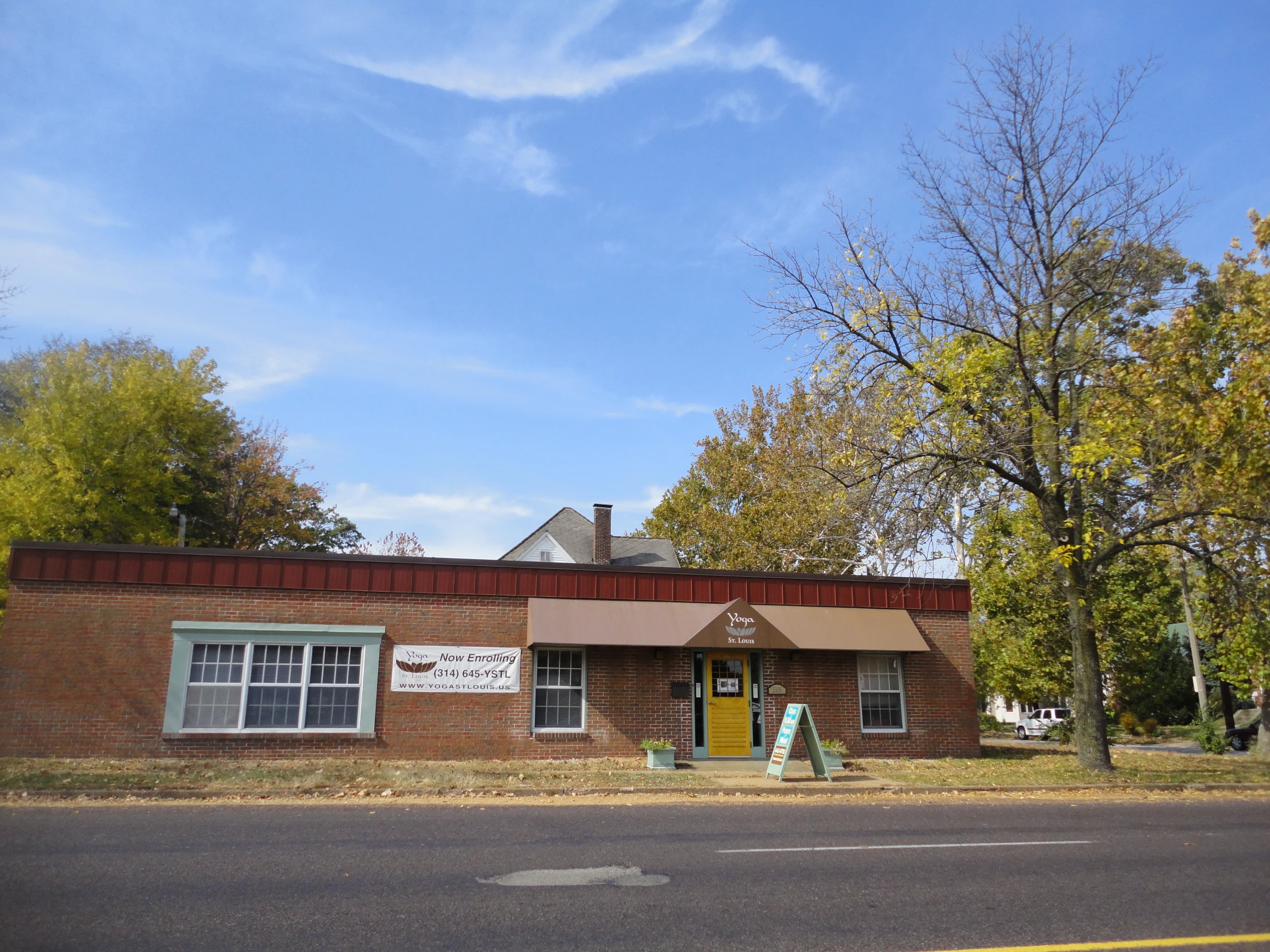 a small building sits on the side of a road