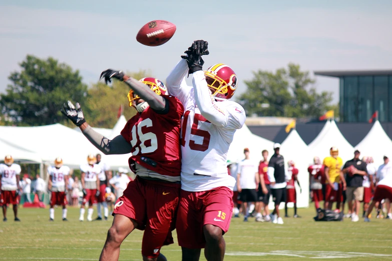 two players on opposing teams try to grab the ball