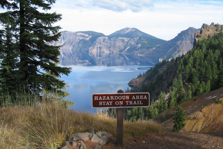 the sign is standing next to the trees