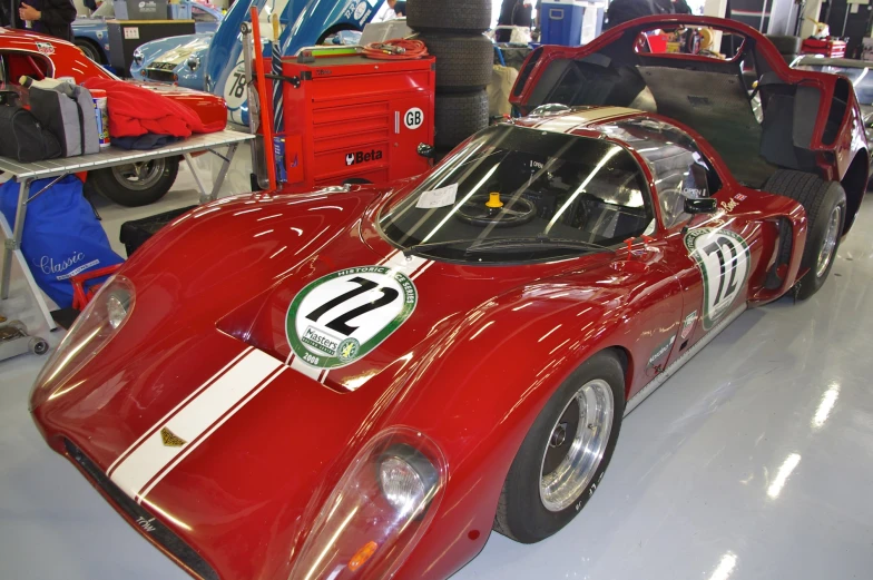 an old fashioned racing car is parked on the ground