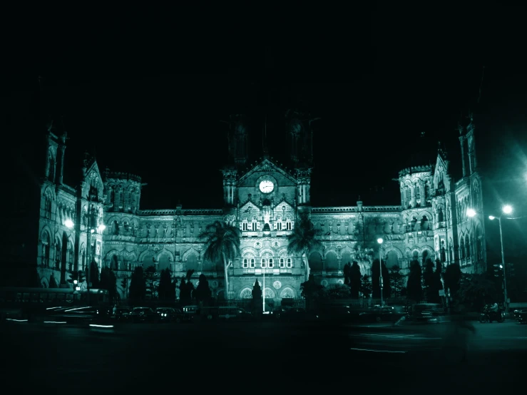 a large building with some tall lights in the background