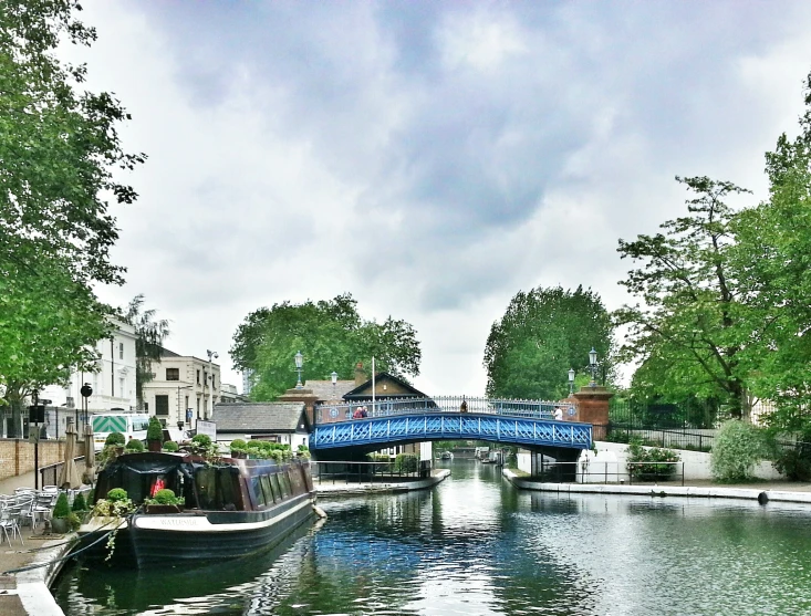 boats are docked next to an overpass in a city