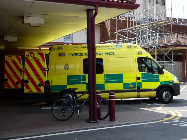 a man on his bike next to an ambulance