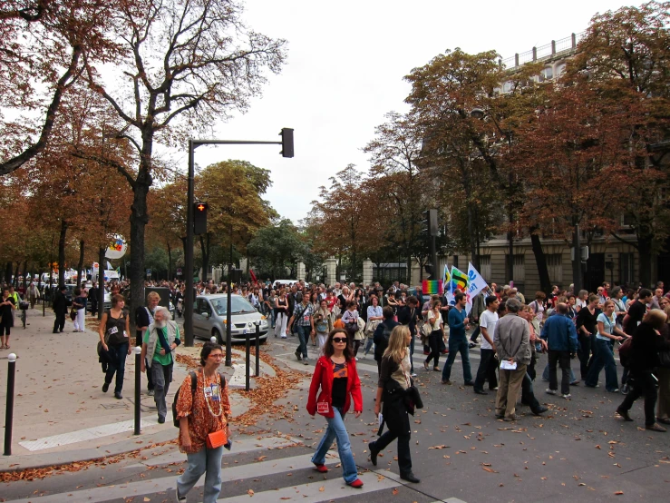 a bunch of people are walking around on a street