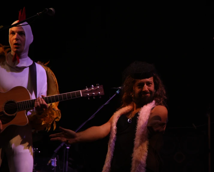 a man in a horned costume holding a guitar