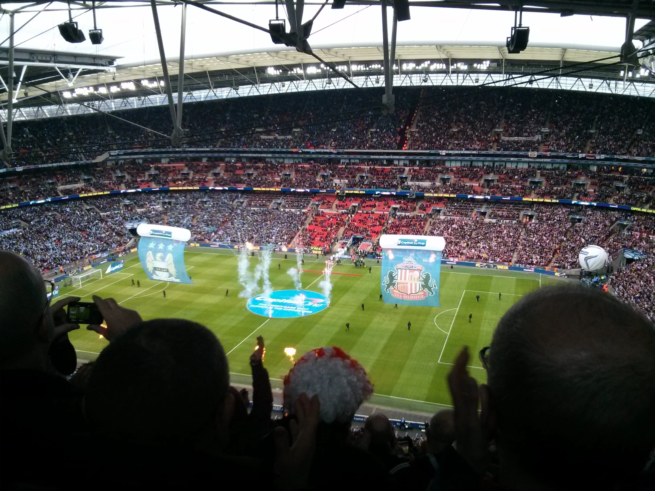 the view of an afl ball game from a packed stadium