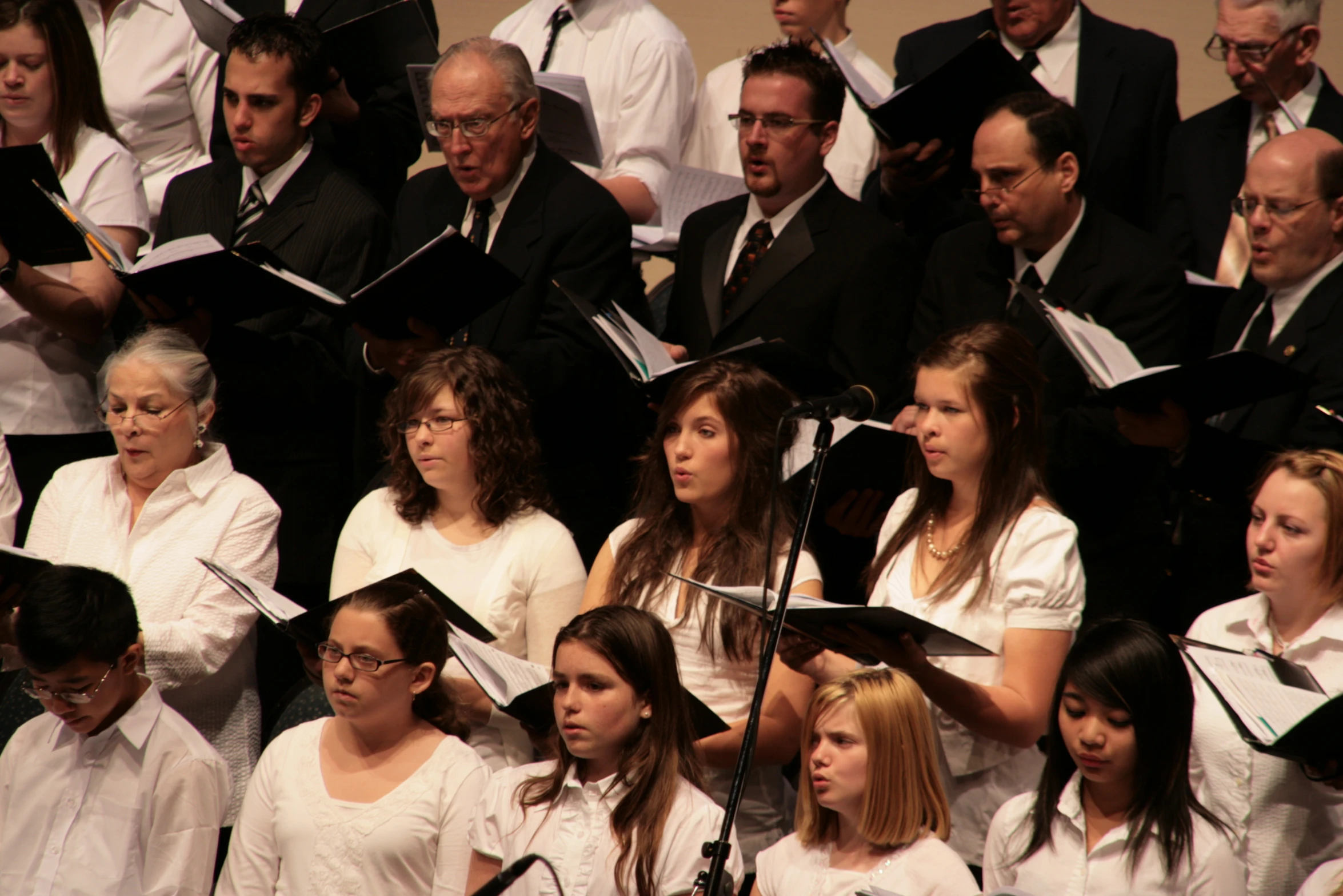 a group of people standing next to each other and singing