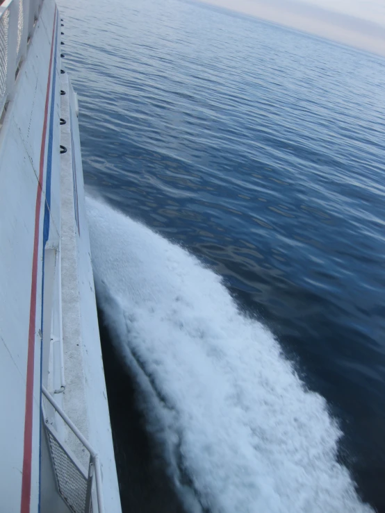 an image of the back end of a boat traveling