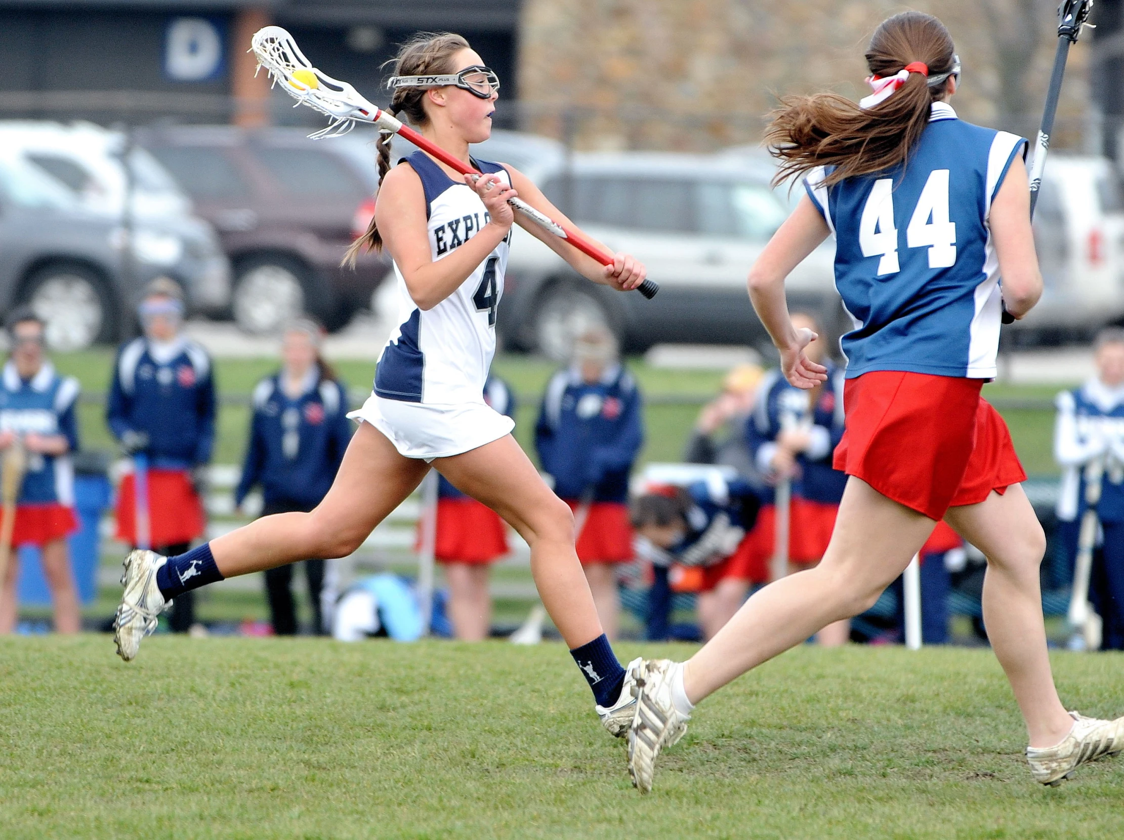 the s are playing lacrosse on the field