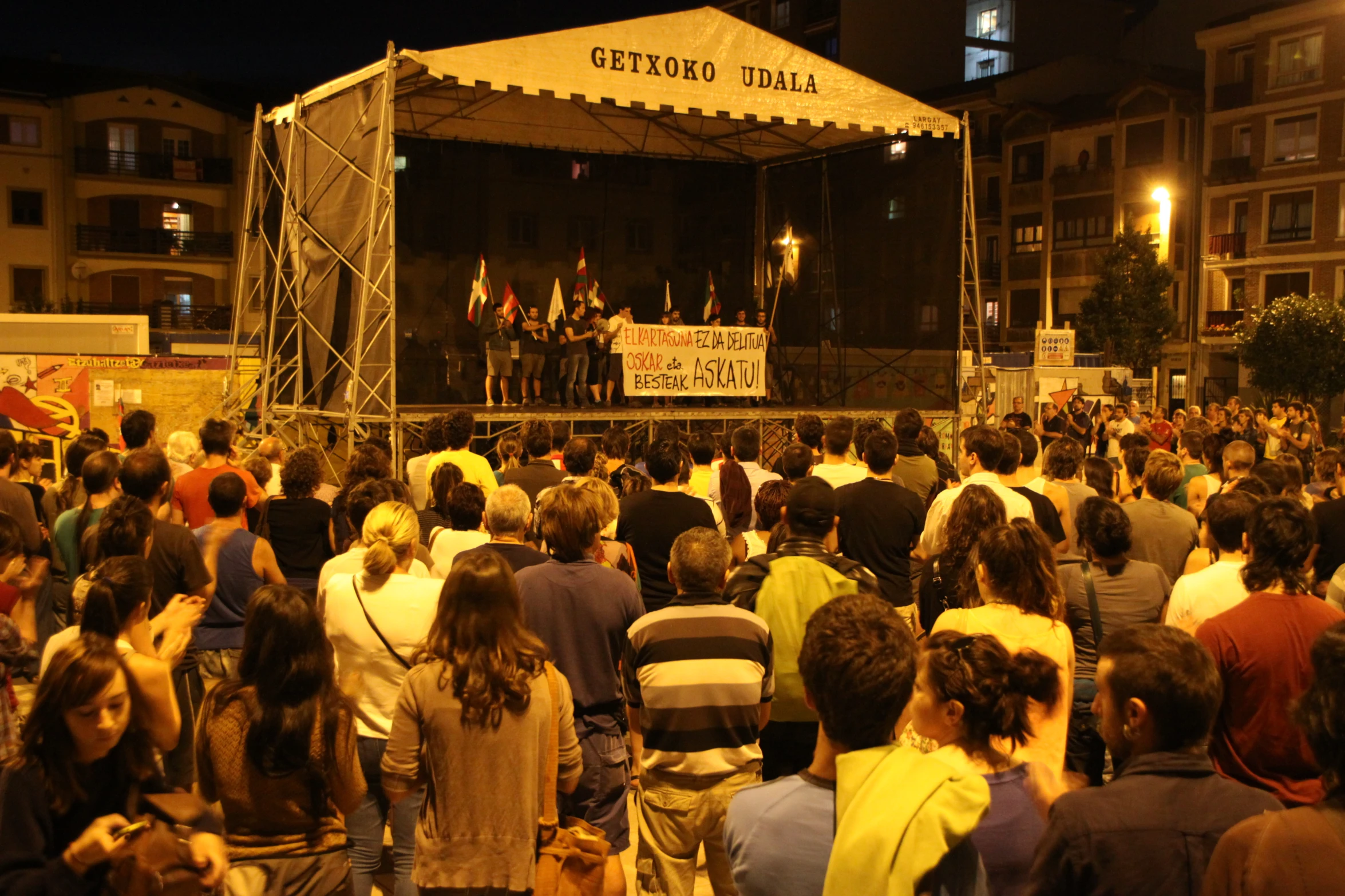 a large crowd of people gather at the outdoor stage
