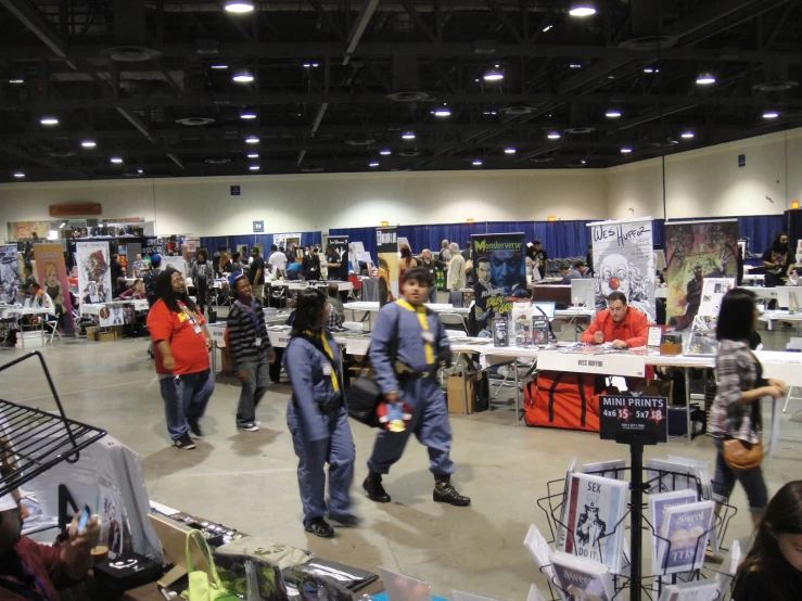 people in a large building looking at goods for sale