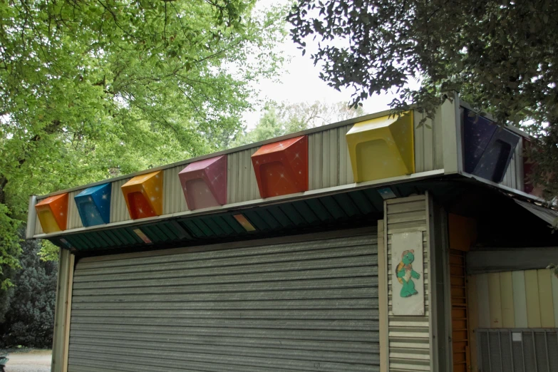 colorful plastic cups sit on top of an old building