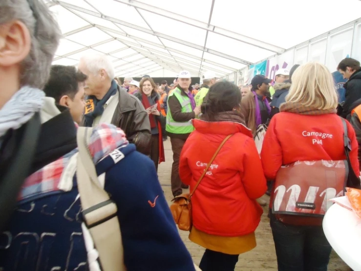 a group of people standing in line waiting for a event to start