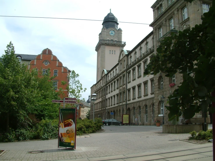 a clock tower sitting above a small square in an old town