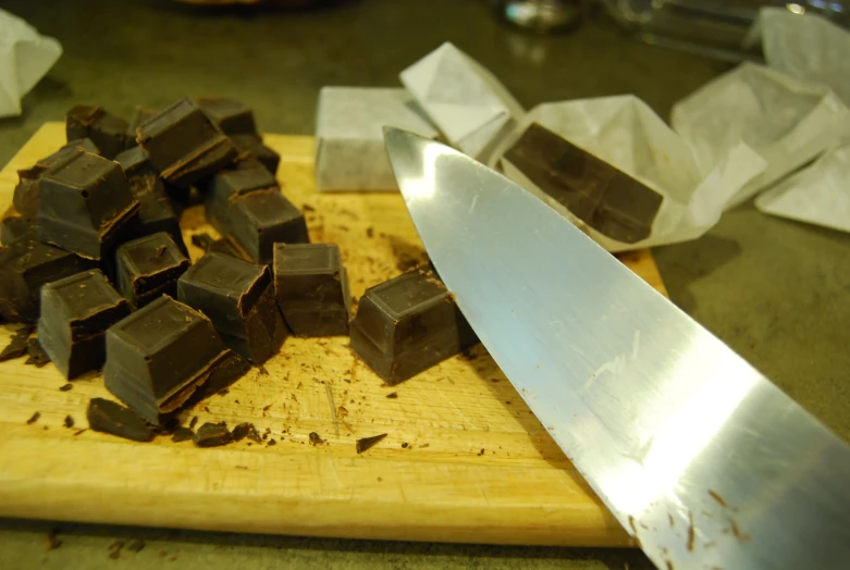 a piece of chocolate and knife on top of a  board